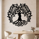 Celtic Tree of Life metal wall art in matte black above a light wood dining table.