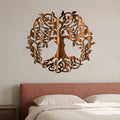 Celtic Tree of Life metal wall art in Copper Bronze with directional grinding marks above a terracotta upholstered bed.