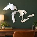 Great Lakes Silhouette metal wall art in Polished Metal finish displayed in a forest-green home study above a walnut desk.