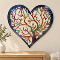 Heart Tree of Life metal wall art with a navy border and colorful airbrushed branches above a light oak entryway console.