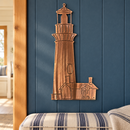 Copper Bronze Lighthouse Metal Wall Art with directional grinding marks displayed on a blue paneled wall in a coastal cottage entryway.
