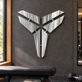 Mamba Logo metal wall art in Polished Metal finish displayed in a contemporary home gym against a charcoal concrete wall.