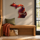 Michigan Home Metal Wall Art in Inferno with directional grinding marks and cutout Home lettering, displayed above an entry bench.