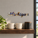 Michigan Metal Wall Art in Torched, displayed at its actual small scale in a coordinated indoor setting.