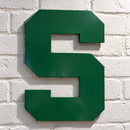 Green metal block S sign mounted on a white brick wall with a clear protective finish.