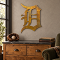 Old English D Metal Wall Art in Rustic, displayed in an indoor baseball fan setting.