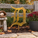 Old English D Metal Yard Art in its golden mottled Rustic finish, planted beside an autumn garden path with the center stake buried.