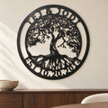Tree of Life Monogram metal wall art in matte black above a walnut sideboard on a pale dining room wall.
