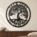 Tree of Life Monogram metal wall art in matte black above a walnut sideboard on a pale dining room wall.
